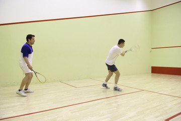 two people playing squash