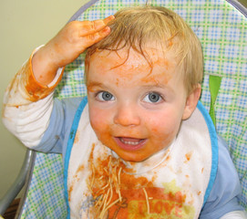boy covered in spaghetti and sauce