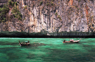 longtail boats in turquoise waters