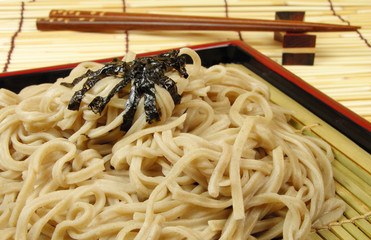 soba and chopsticks on a bamboo floor
