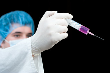 medical worker holding a syringe