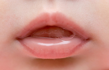 close up of lips of baby girl - obrazy, fototapety, plakaty