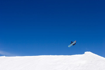 Naklejka na ściany i meble huge snowboarding jump on slopes of ski resort in spain
