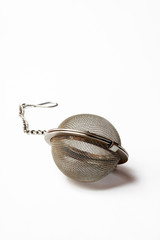 stainless steel tea ball on white background