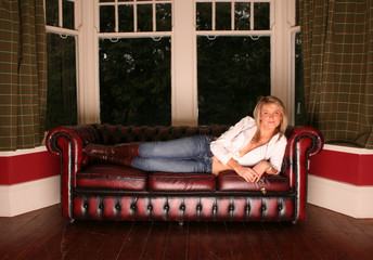 Obraz premium sexy girl on a leather sofa