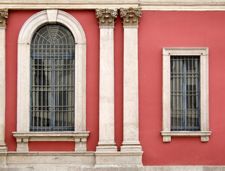 red wall and ornate windows