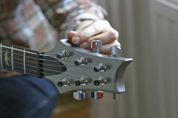 girl tuning guitar