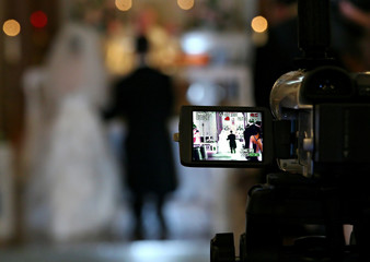 bride and groom on videotape - obrazy, fototapety, plakaty