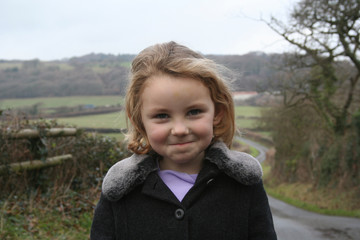 cheeky looking girl on country walk