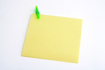 isolated yellow paper with green clamp