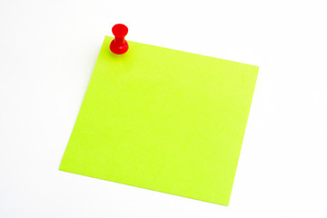 isolated green paper with red pushnail