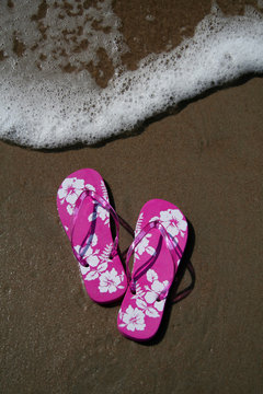 pink flip-flops on the sand