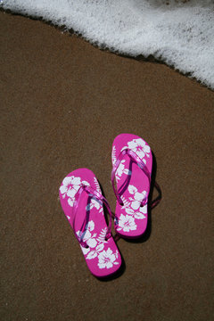 pink flip-flops on the sand