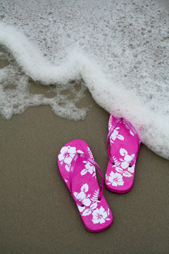 pink flip-flops on the sand