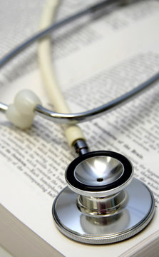 white stethoscope on a medical book