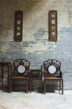 chinese chairs by brick wall