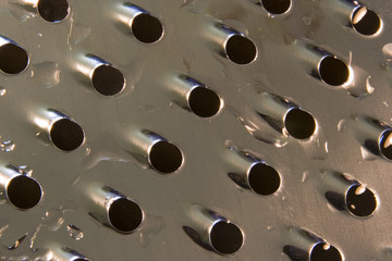 wet cheese grater close up.