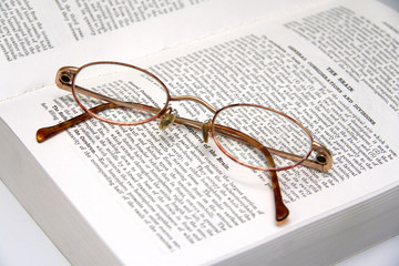 pair of glasses on a medical book