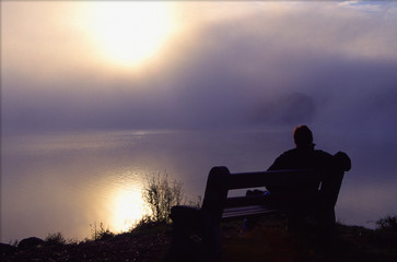 man enjoys peaceful morning by the lake