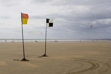 lifeguards flags and kite surfers