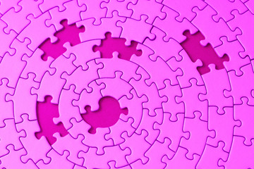 jigsaw in pink with five missing pieces