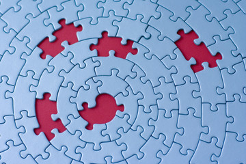 jigsaw in blue with five missing pieces