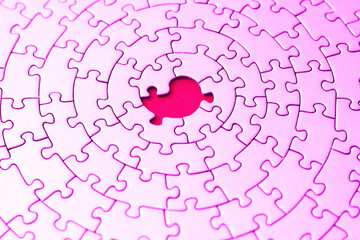 abstract of a pink jigsaw with one missing piece