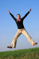 happily jumping fit attractive woman