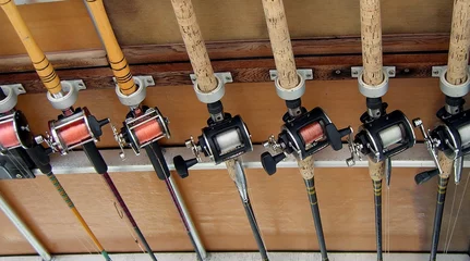 Zelfklevend Fotobehang fishing rods and reels © Kenneth Summers