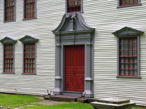 front of vintage colonial house.