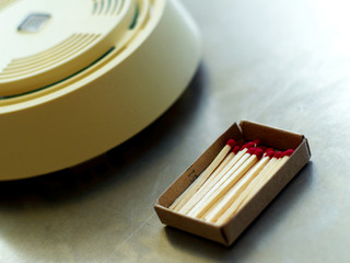 boxed wooden matches and smoke detector