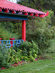 chinese pagoda-style gazebo amidst plants and tree