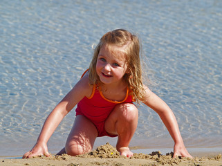 girl playing in sand