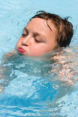 a boy in a swimming pool