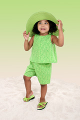 beautiful young girl standing in the sand