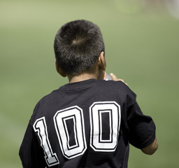 boy soccer player watching the action