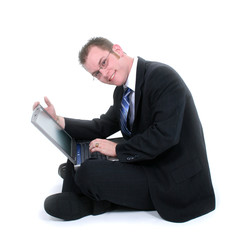 attractive young businessman sitting on floor with