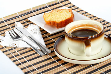 sponge cake with the spoon inside cup of coffee, k