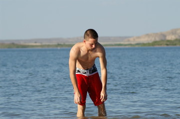 Fototapeta na wymiar teenage boy at lake