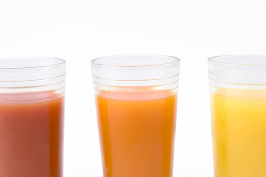 glass of orange tomato and kiwi juice - close up
