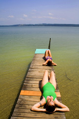 two beauties bathing on lakeside