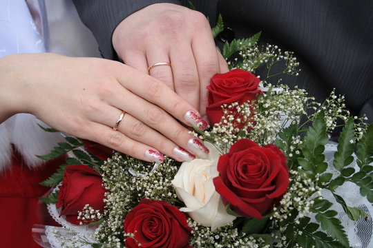 hands of the bridegroom and bride