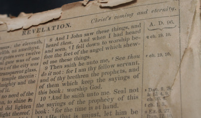 very old bible opened to revelation