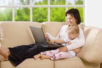clipping path! mother with daughter on the sofa