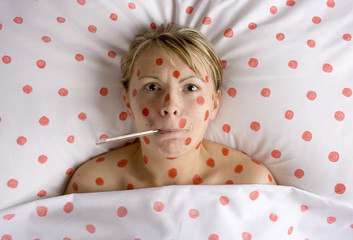 woman with red spots on face and body