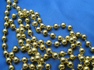 golden beads on blue background