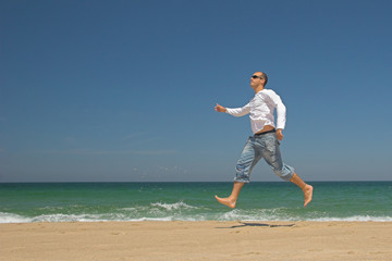 man jumping on the beach