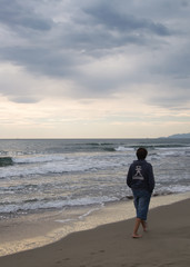 man walking in the beach