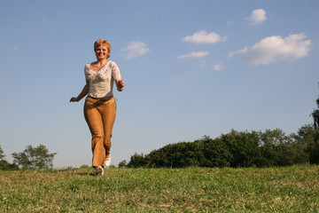Obraz na płótnie Canvas running girl on meadow