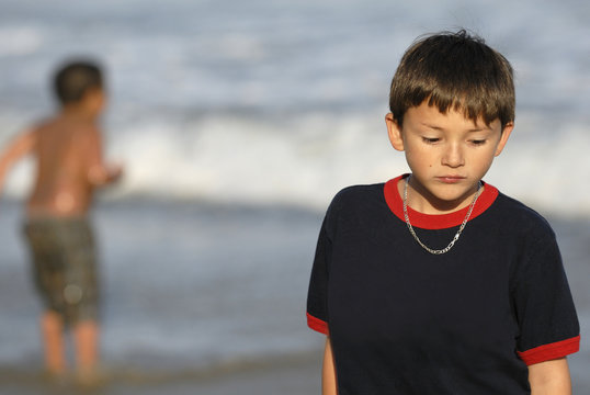 boy feeling sad at the beach